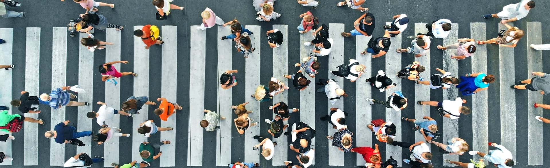 aerial view of people in a crosswalk-min